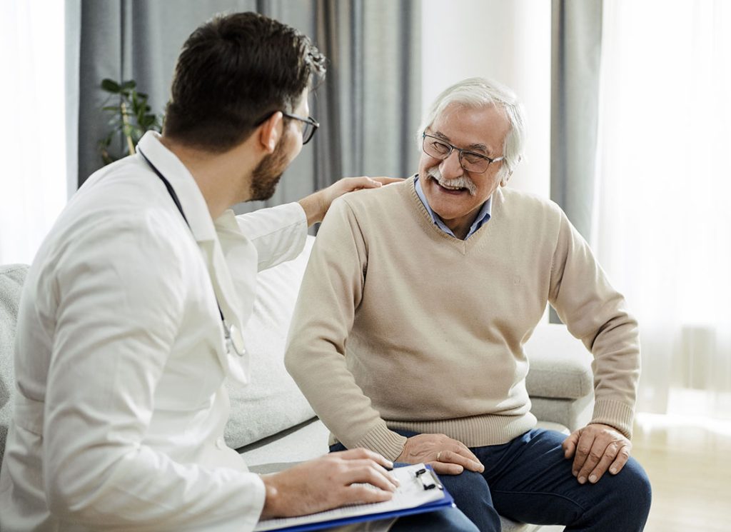 Audiologist consulting a senior patient on whether he needs hearing aids.