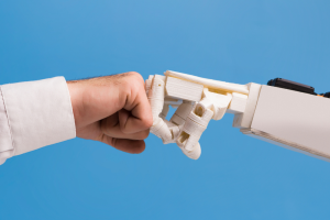 Audiologist and robot giving each other a fistbump